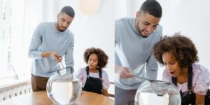 Father and daughter cleaning a small fish tank